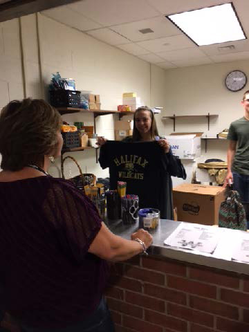 Student holding Halifax Tee Shirt