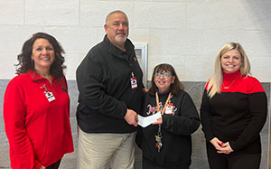 Nicole Dull, Ed Albert, Deb Mishler receiving her grant check, and Samantha Rosa