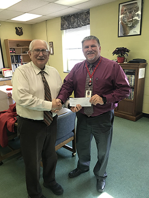 Superintendent David Burkett from Fannett-Metal presents the teacher grant award to Mr. Mattern Mellot.