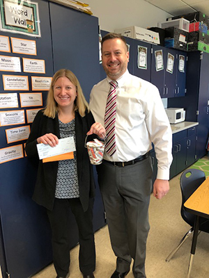 Dr. Christian Haller, principal in the Octorara School District, presents the grant check to Mrs. Christina Gray.