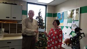 Eric Zelanko, superintendent of Portage SD, presents the PARSS grant check to his staff member.