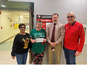 Adele Hopkins (board vice president), Tadem Perok (teacher), Steve Shields (elementary principal), and Ken Wiltz (board president)