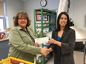 Sarah Batson receives her grant from Superintendent Jacki Canter