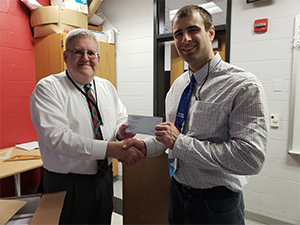 Mr. John Chelednik receives his check from the superintendent.
