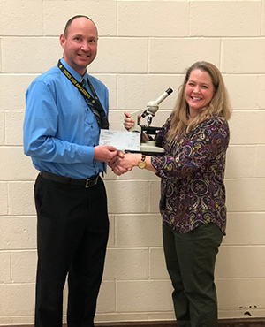 Nicole Keller receives her check from the principal.